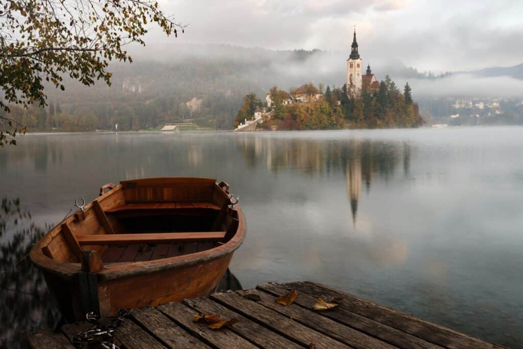 A boat is moored on the coast of a mystical lake.